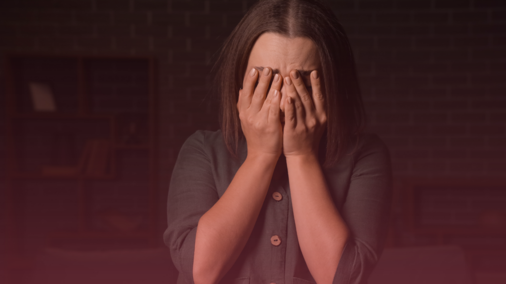 A distressed woman covering her face, representing situations where a MIAM exemption may apply.