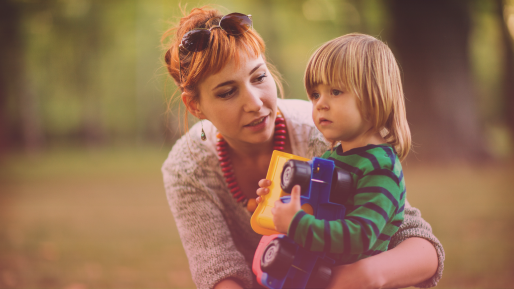 A parent and child together in a park.