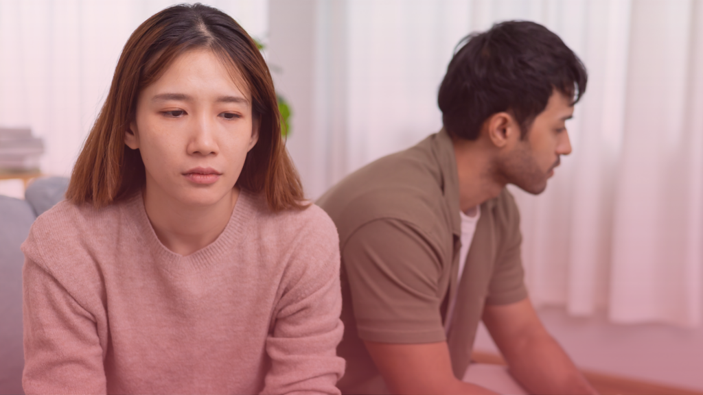 A separated couple facing away from each other considering shuttle mediation.